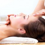 Hands massaging female face at the spa